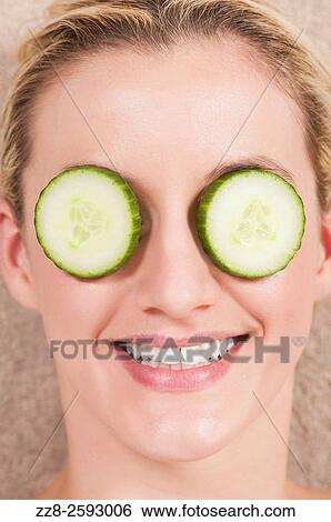 Woman with slices of cumbers covering her eyes. View Large Photo Image Stock Photograph - Woman with slices of cumbers covering her eyes.. Fotosearch