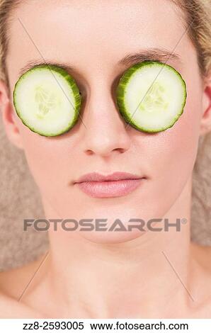 Woman with slices of cumbers covering her eyes. View Large Photo Image Stock Photography - Woman with slices of cumbers covering her eyes.. Fotosearch