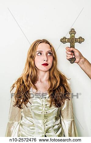 Woman's hand holding a cross next to a blonde teenage girl. View Large Photo Image Stock Photograph - Woman's hand holding a cross next to a blonde teenage girl.. Fotosearch