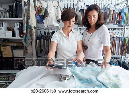 Women entrepreneurs. Fabric colors and upholstery. Decoration store. Donostia. San Sebastian. Gipuzkoa. Basque Country. Spain View Large Photo Image Stock Photo - Women entrepreneurs. Fabric colors and upholstery. Decoration store. Donostia. San Sebastian. Gipuzkoa. Basque Country. Spain. Fotosearch