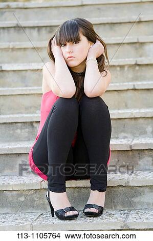Worried teenager girl is sitting on steps View Large Photo Image Picture - Worried teenager girl is sitting on steps. Fotosearch