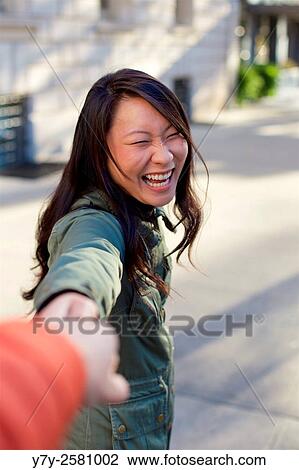 Young Asian woman pulls the onlooker towards her. View Large Photo Image Stock Image - Young Asian woman pulls the onlooker towards her.. Fotosearch