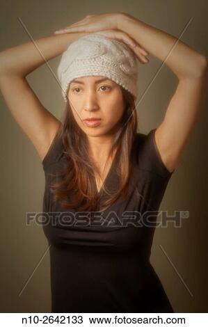 Young Asian woman wearing a hat. View Large Photo Image Stock Image - Young Asian woman wearing a hat.. Fotosearch