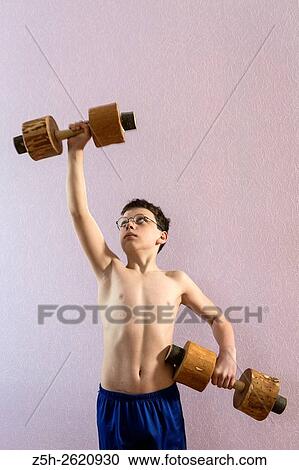 Young athlete exercise with wooden dumbbells. View Large Photo Image Stock Image - Young athlete exercise with wooden dumbbells.. Fotosearch