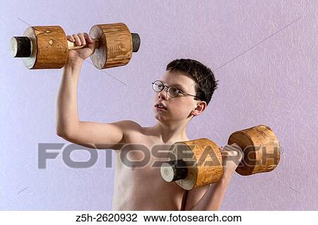 Young athlete exercise with wooden dumbbells. View Large Photo Image Stock Image - Young athlete exercise with wooden dumbbells.. Fotosearch