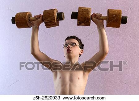 Young athlete exercise with wooden dumbbells. View Large Photo Image Stock Image - Young athlete exercise with wooden dumbbells.. Fotosearch