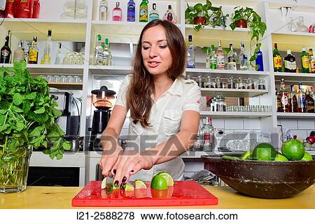 Young female bartender cutting lemons, preparing cocktails. Woman barman at work. View Large Photo Image Stock Photo - Young female bartender cutting lemons, preparing cocktails. Woman barman at work.. Fotosearch