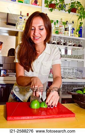 Young female bartender cutting lemons, preparing cocktails. Woman barman at work. View Large Photo Image Stock Photograph - Young female bartender cutting lemons, preparing cocktails. Woman barman at work.. Fotosearch