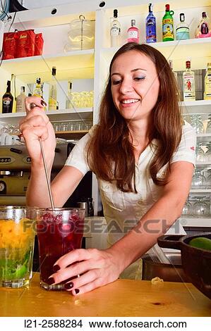 Young female bartender preparing cocktails. Woman barman at work. View Large Photo Image Picture - Young female bartender preparing cocktails. Woman barman at work.. Fotosearch