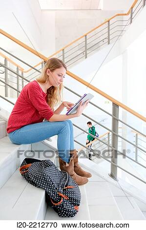 Young female student with digital tablet at campus View Large Photo Image Stock Image - Young female student with digital tablet at campus. Fotosearch