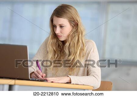 Young female student with laptop at campus View Large Photo Image Stock Image - Young female student with laptop at campus. Fotosearch