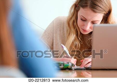 Young female student with laptop at campus View Large Photo Image Stock Image - Young female student with laptop at campus. Fotosearch