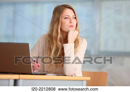 Young female student with laptop at campus View Large Photo Image Stock Photo - Young female student with laptop at campus. Fotosearch