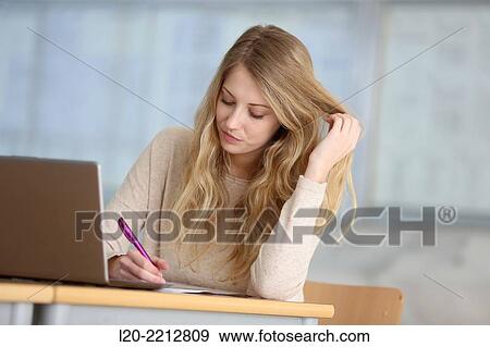 Young female student with laptop at campus View Large Photo Image Stock Photo - Young female student with laptop at campus. Fotosearch
