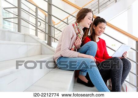 Young female students with digital tablet at campus View Large Photo Image Picture - Young female students with digital tablet at campus. Fotosearch