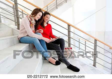 Young female students with digital tablet at campus View Large Photo Image Stock Image - Young female students with digital tablet at campus. Fotosearch
