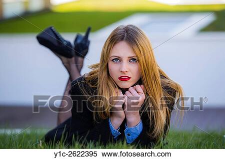 Young lady lying on meadow with crossed legs View Large Photo Image Stock Photography - Young lady lying on meadow with crossed legs. Fotosearch