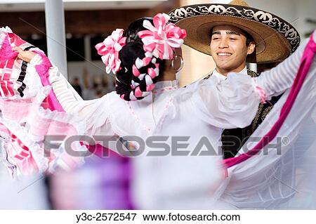 Young man and woman dancing. Puerto Vallarta, Jalisco, Mexico. Xiutla Dancers - a folkloristic Mexican dance group in traditional costumes representing the culture and different regions of Mexico. View Large Photo Image Stock Photo - Young man and woman dancing. Puerto Vallarta, Jalisco, Mexico. Xiutla Dancers - a folkloristic Mexican dance group in traditional costumes representing the culture and different regions of Mexico.. Fotosearch
