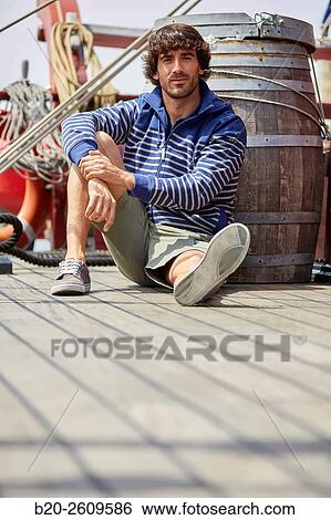 Stock Photograph - Young man in a sailboat, galleon. Basque Country. Spain. Fotosearch
