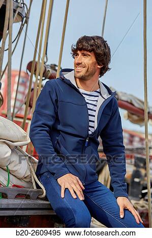 Stock Photography - Young man in a sailboat, galleon. Basque Country. Spain. Fotosearch