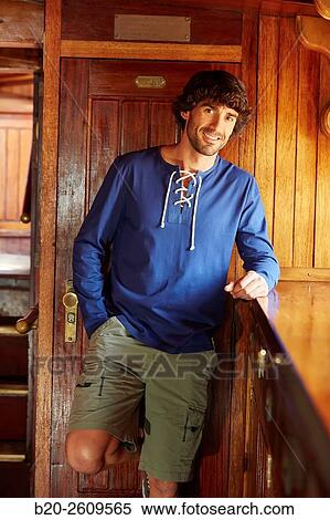 Stock Photography - Young man in a sailboat, galleon. Basque Country. Spain. Fotosearch