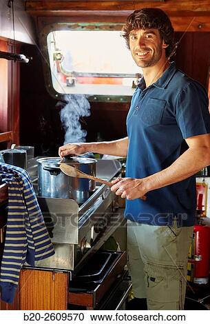 Young man in the kitchen of a sailboat, galleon. Basque Country. Spain View Large Photo Image Stock Image - Young man in the kitchen of a sailboat, galleon. Basque Country. Spain. Fotosearch