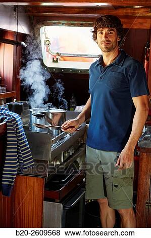 Young man in the kitchen of a sailboat, galleon. Basque Country. Spain View Large Photo Image Stock Photo - Young man in the kitchen of a sailboat, galleon. Basque Country. Spain. Fotosearch