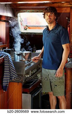 Young man in the kitchen of a sailboat, galleon. Basque Country. Spain View Large Photo Image Stock Photo - Young man in the kitchen of a sailboat, galleon. Basque Country. Spain. Fotosearch