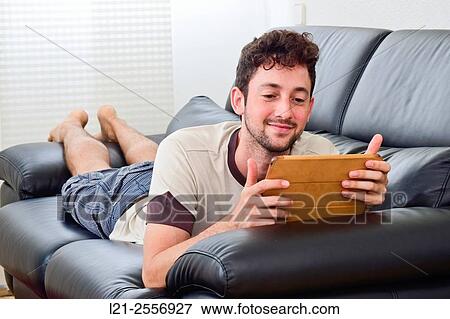 Young man with digital tablet View Large Photo Image Stock Photo - Young man with digital tablet. Fotosearch