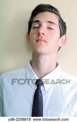 Young man with eyes closed View Large Photo Image Stock Photo - Young man with eyes closed. Fotosearch