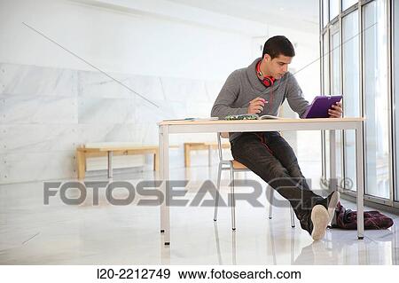 Young student with digital tablet at campus View Large Photo Image Stock Photo - Young student with digital tablet at campus. Fotosearch