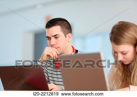 Stock Photo - Young student with laptop at campus. Fotosearch
