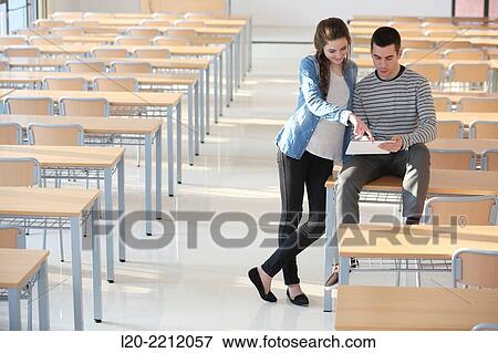 Stock Photo - Young students at campus using digital tablet. Fotosearch