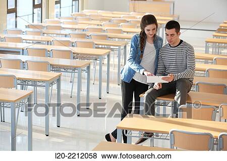 Young students at campus using digital tablet View Large Photo Image Stock Photo - Young students at campus using digital tablet. Fotosearch