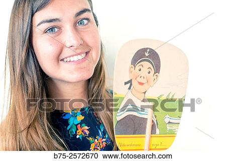 Young teen with long brown hair and blue eyes, looking at the camera, with a fan in a hand. View Large Photo Image Stock Image - Young teen with long brown hair and blue eyes, looking at the camera, with a fan in a hand.. Fotosearch