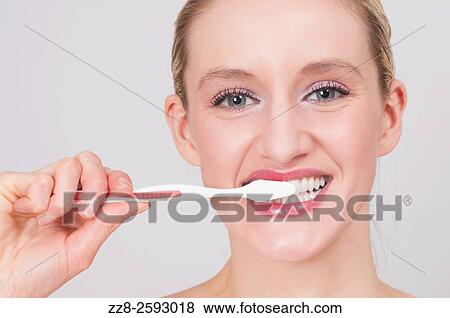 Young woman brushing her teeth with toothbrush. View Large Photo Image Stock Photo - Young woman brushing her teeth with toothbrush.. Fotosearch