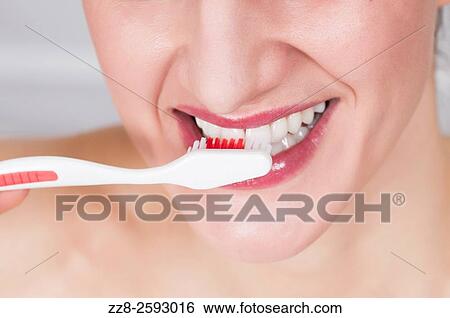Young woman brushing her teeth with toothbrush. View Large Photo Image Stock Photograph - Young woman brushing her teeth with toothbrush.. Fotosearch
