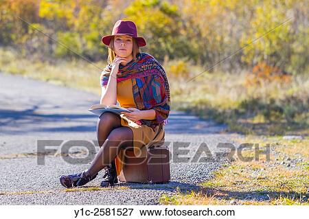 Young woman dressed old-fashioned is waiting for transport View Large Photo Image Stock Photo - Young woman dressed old-fashioned is waiting for transport. Fotosearch
