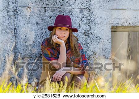 Stock Photo - Young woman dressed old-fashioned is waiting for transport. Fotosearch