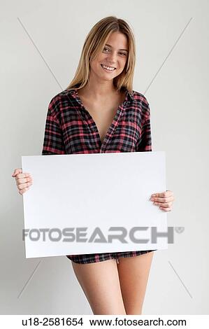 Picture - Young woman holding blank sign. Fotosearch