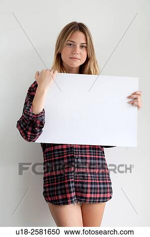 Young woman holding blank sign View Large Photo Image Stock Image - Young woman holding blank sign. Fotosearch