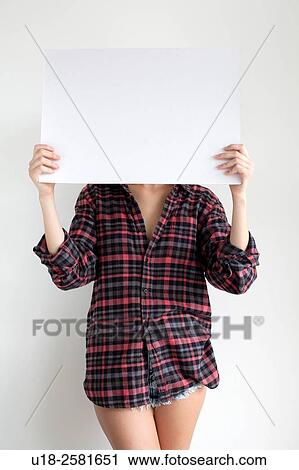 Stock Image - Young woman holding blank sign. Fotosearch