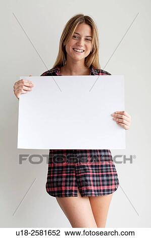 Stock Image - Young woman holding blank sign. Fotosearch