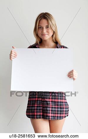 Young woman holding blank sign View Large Photo Image Stock Image - Young woman holding blank sign. Fotosearch