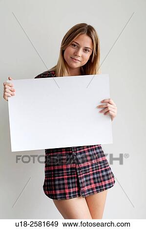 Young woman holding blank sign View Large Photo Image Stock Photo - Young woman holding blank sign. Fotosearch
