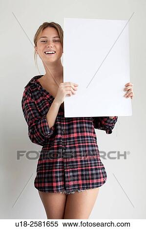 Young woman holding blank sign View Large Photo Image Stock Photography - Young woman holding blank sign. Fotosearch