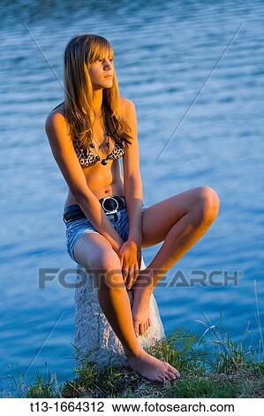 Young woman is watching sunset View Large Photo Image Stock Image - Young woman is watching sunset. Fotosearch