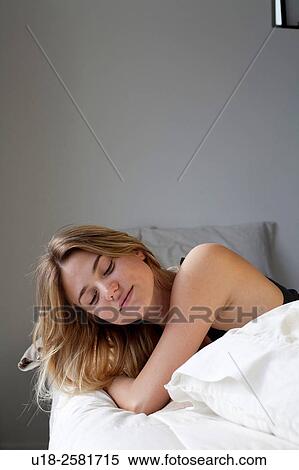 Young woman on bed View Large Photo Image Stock Photography - Young woman on bed. Fotosearch