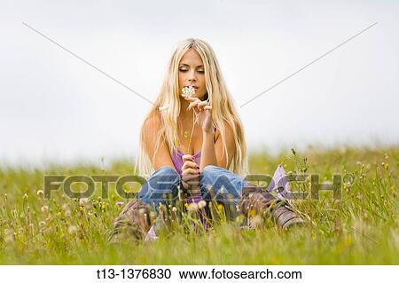 Young woman on the grass View Large Photo Image Stock Image - Young woman on the grass. Fotosearch