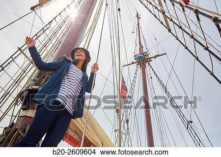 Young woman on the outside of a sailboat, galleon. Masts. Basque Country. Spain View Large Photo Image Picture - Young woman on the outside of a sailboat, galleon. Masts. Basque Country. Spain. Fotosearch